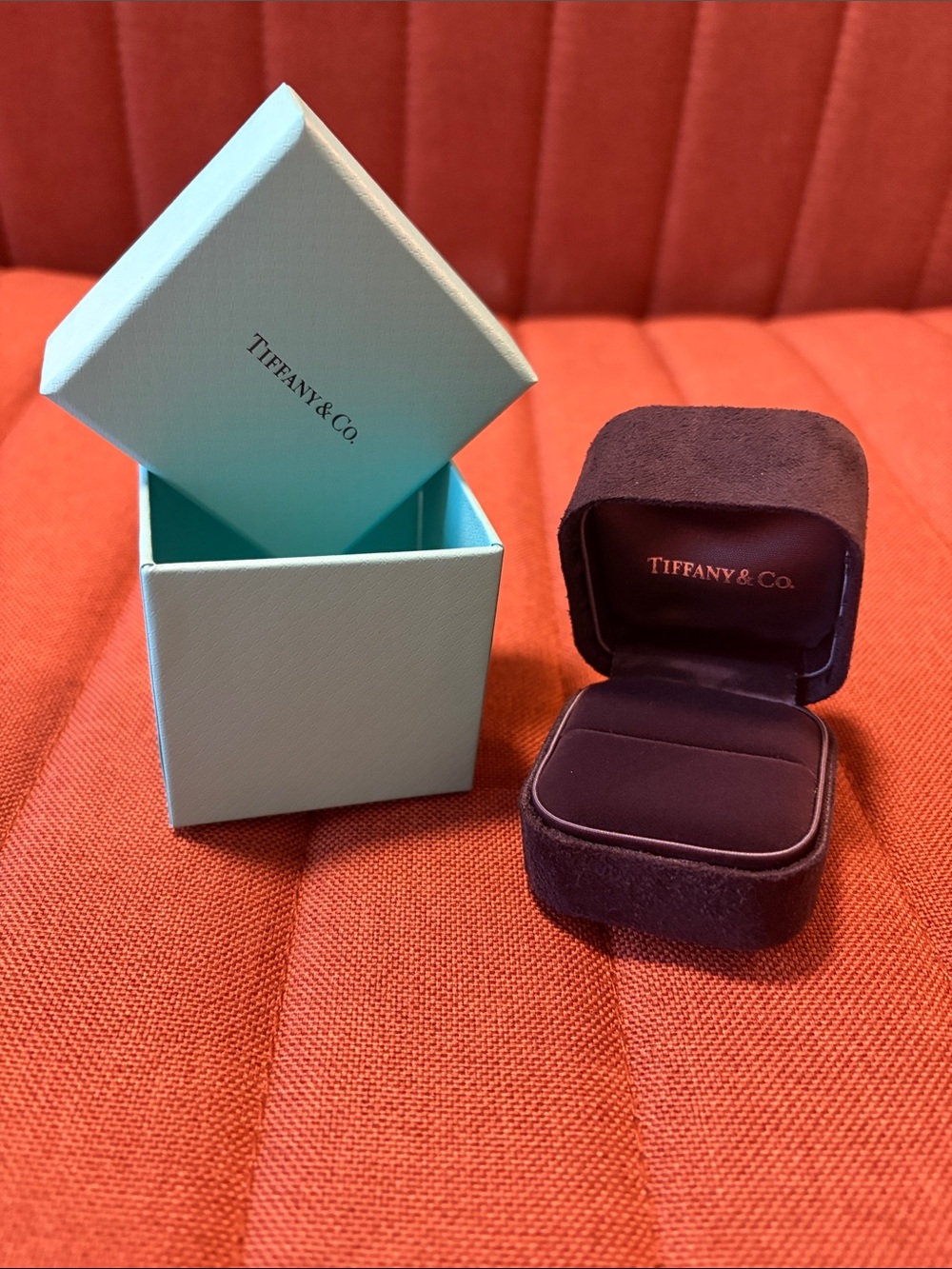 Tiffany & Co. light blue gift box with dark purple velvet ring case